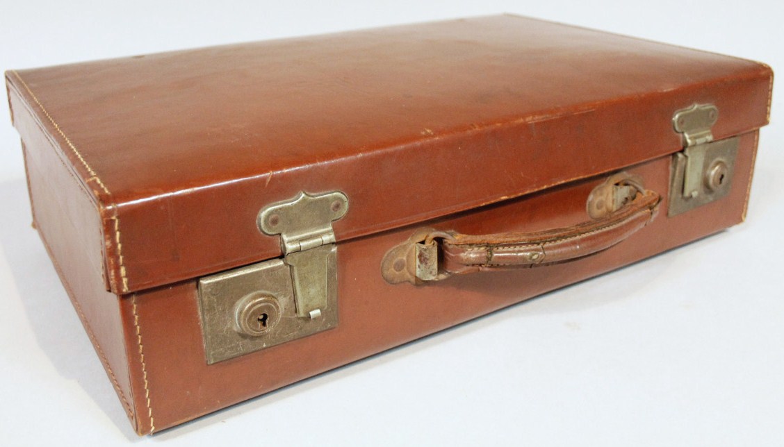 Appraisal: An early thC pressed brown leather travel case with metal