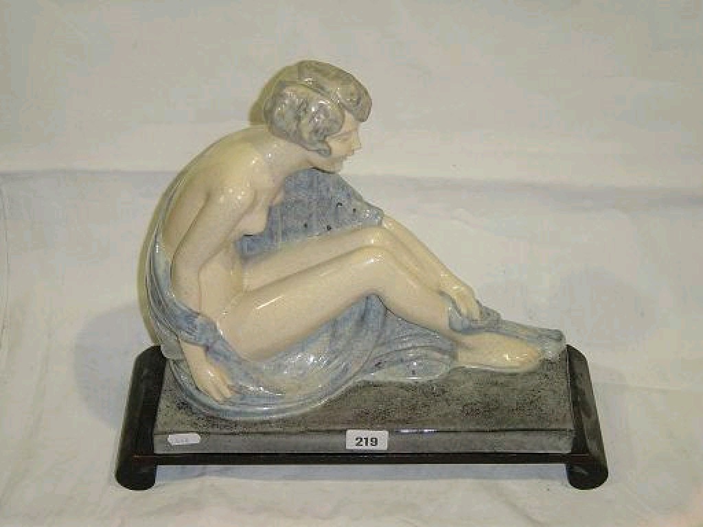 Appraisal: An Art Deco ceramic figure of a seated naked female