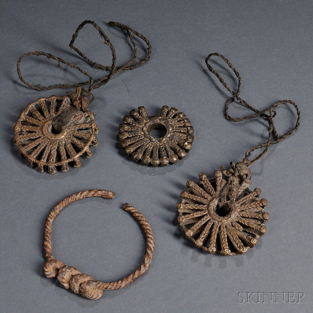 Appraisal: Three Dogon Brass Sunburst Pendants and a Forged Iron Bracelet