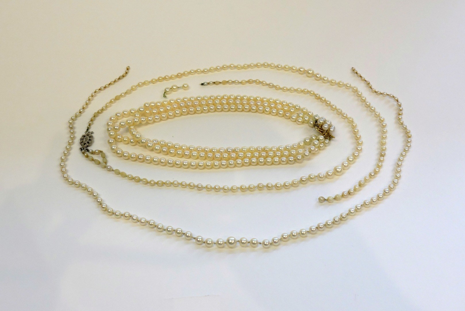 Appraisal: A three row necklace of uniform cultured pearls on a