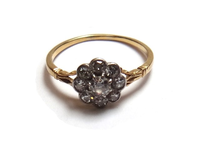 Appraisal: A gold and diamond set nine stone cluster ring claw