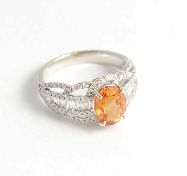 Appraisal: ORANGE SAPPHIRE AND DIAMOND RING k white gold with round-cut