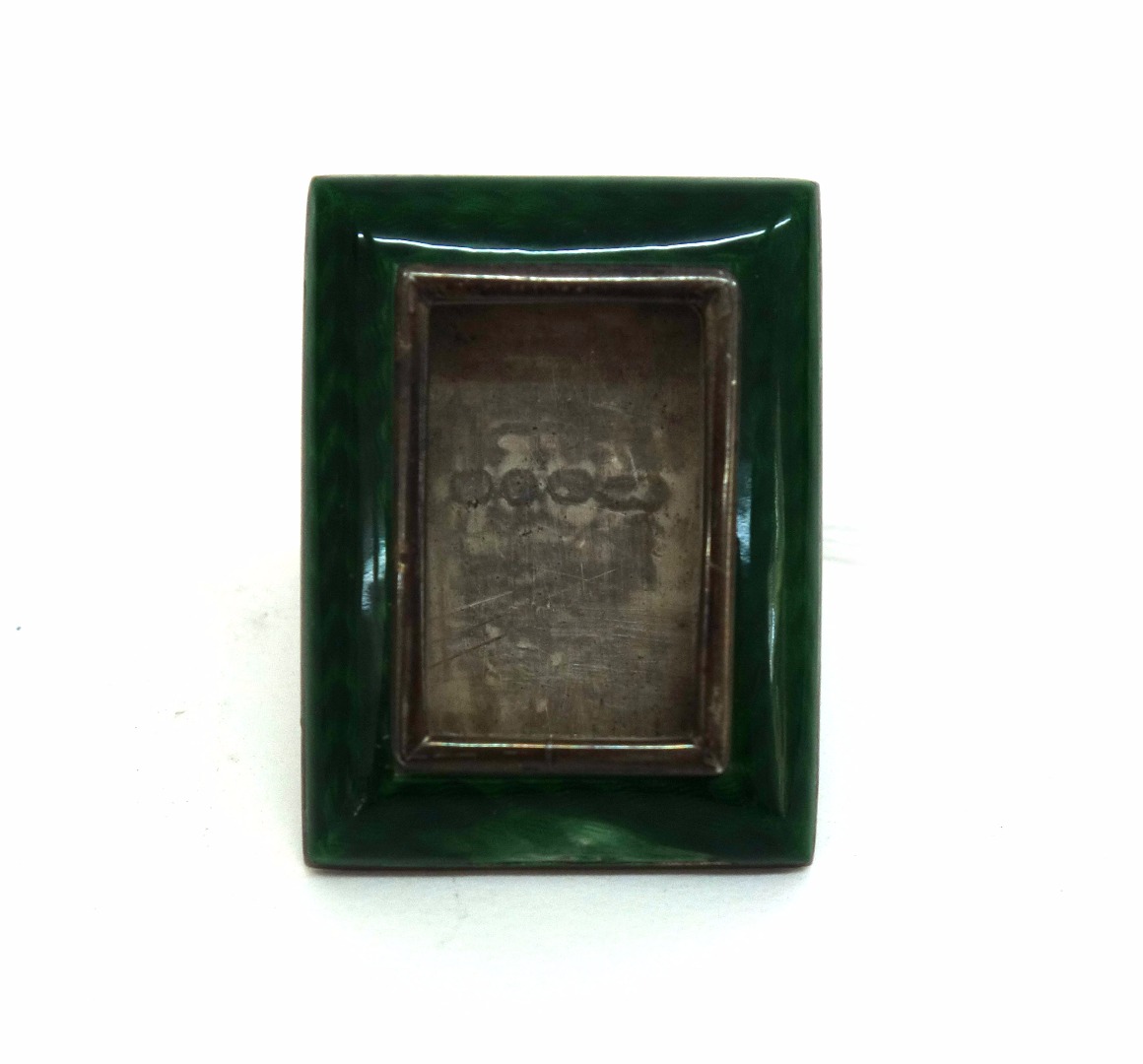 Appraisal: A miniature Victorian silver and green guilloche enamel easel photograph