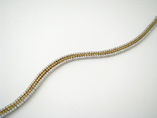 Appraisal: K White and yellow gold triple strand diamond bracelet with