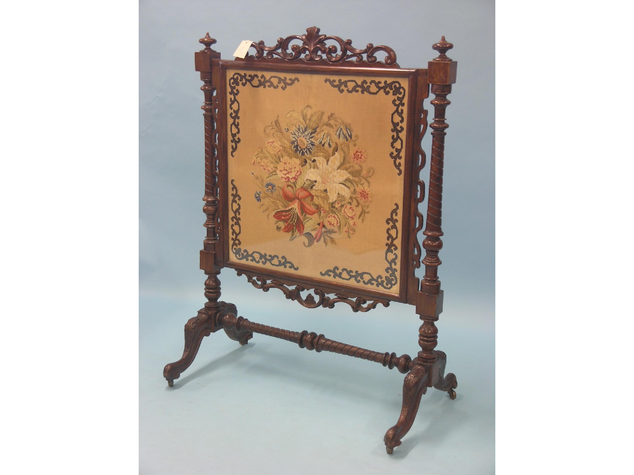 Appraisal: A large Victorian walnut firescreen inset floral petit-point needlework panel