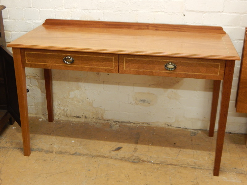 Appraisal: A modern mahogany Edwardian style side table with two frieze