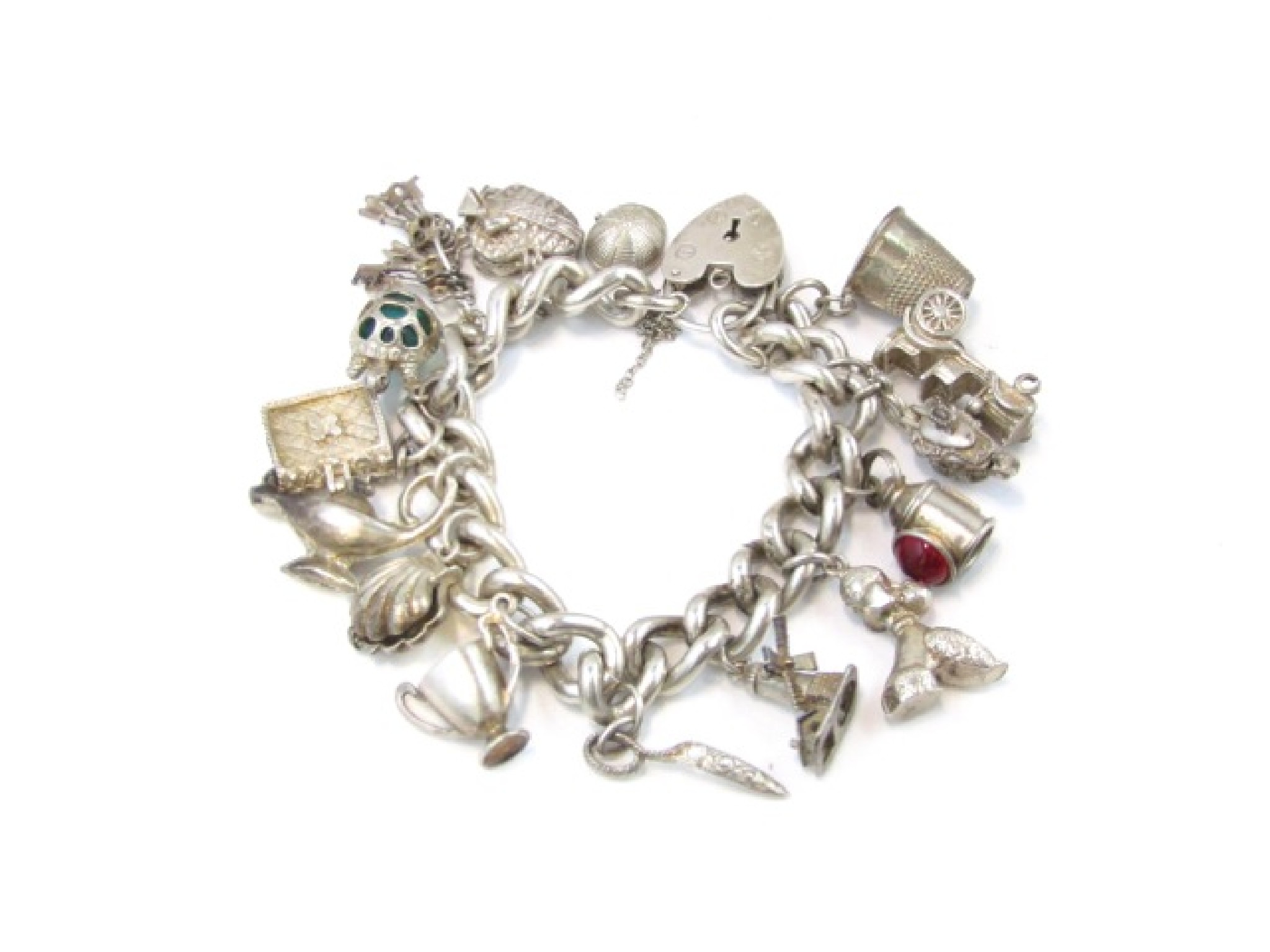 Appraisal: A silver charm bracelet with heart-shaped padlock clasp suspended with