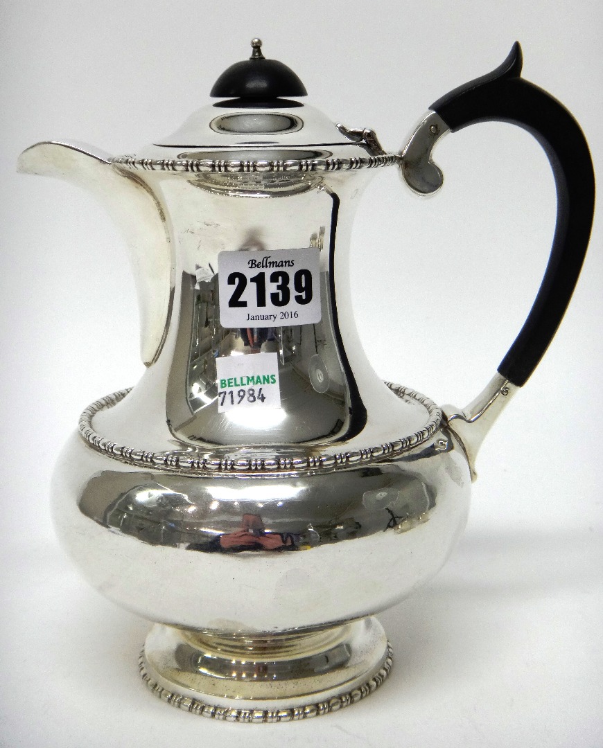 Appraisal: A silver hot water jug of baluster form decorated with