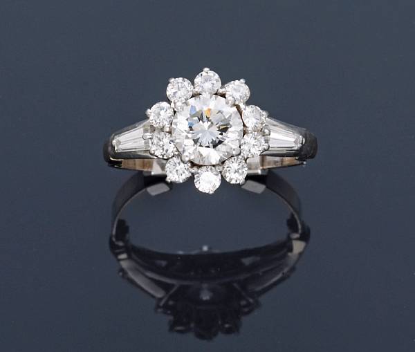 Appraisal: A diamond ring centering a round brilliant-cut diamond principal diamond