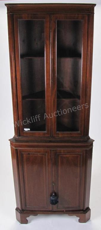 Appraisal: A period-style mahogany corner cabinet glass doors upper section ca