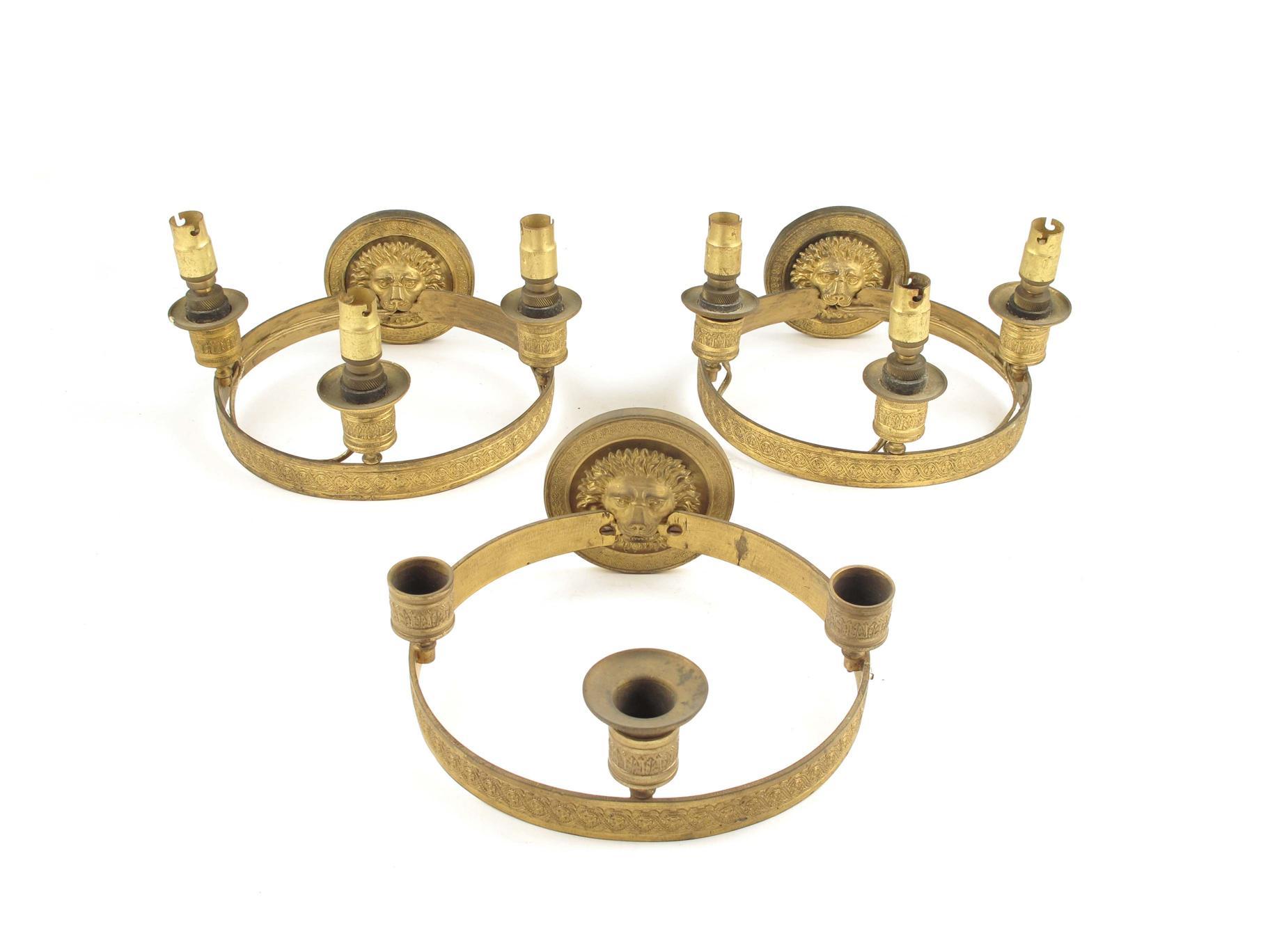 Appraisal: A set of three gilt brass wall lights