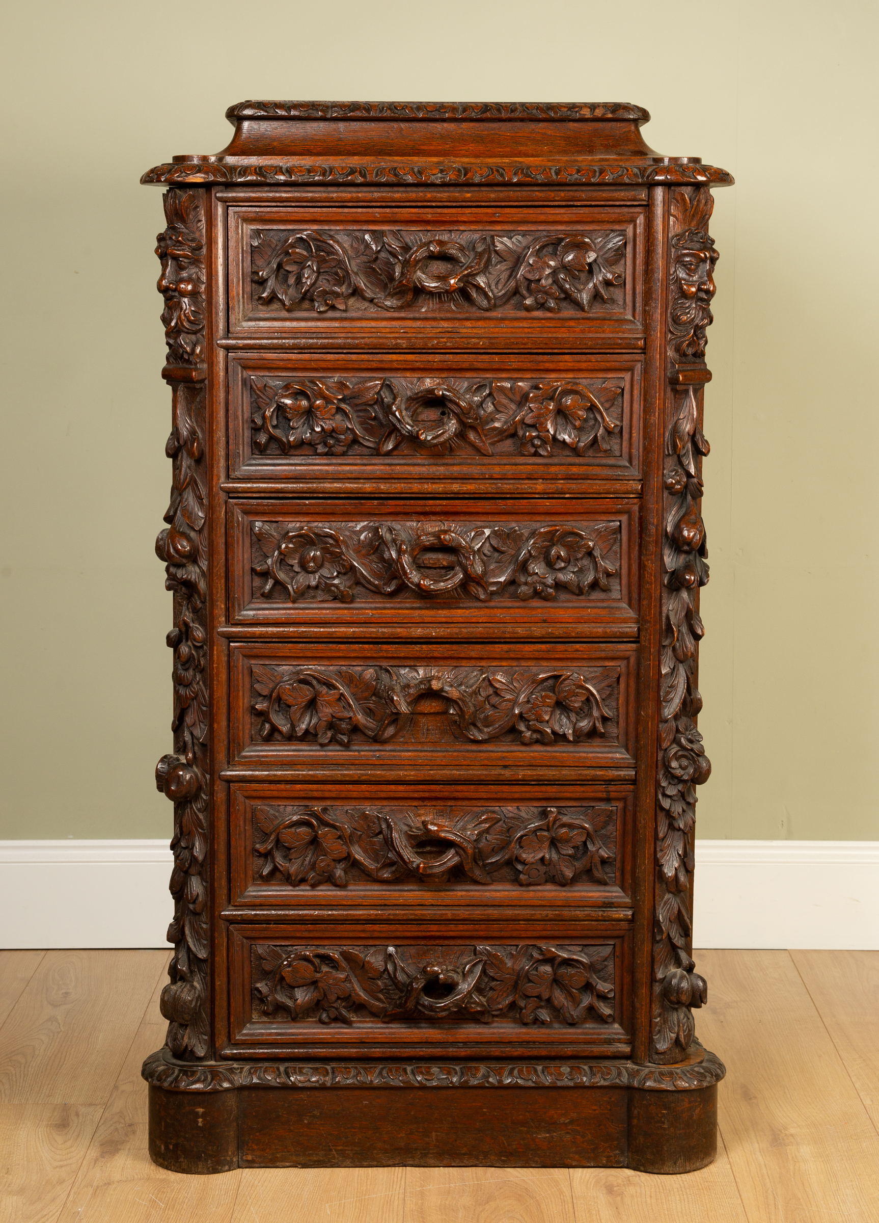 Appraisal: A Victorian carved oak Wellington chest with six drawers decorated