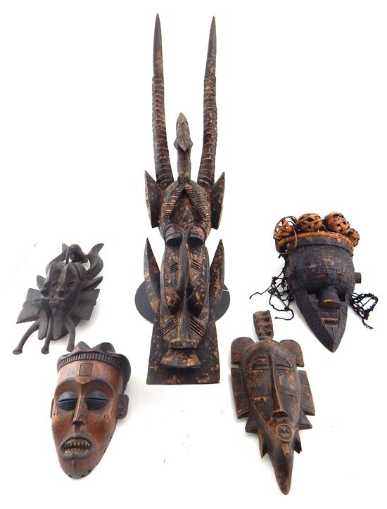 Appraisal: TRIBAL Five African carvings four masks and one wall hanging