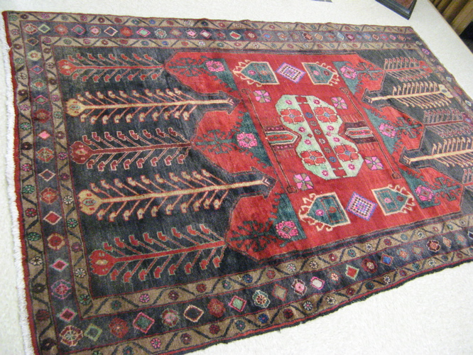 Appraisal: PERSIAN MALAYER CARPET centering a cluster of geometric shapes and