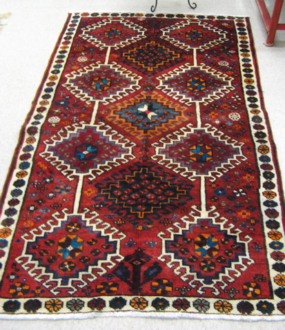 Appraisal: PERSIAN TRIBAL AREA RUG repeating diamond-shaped panels over all hand