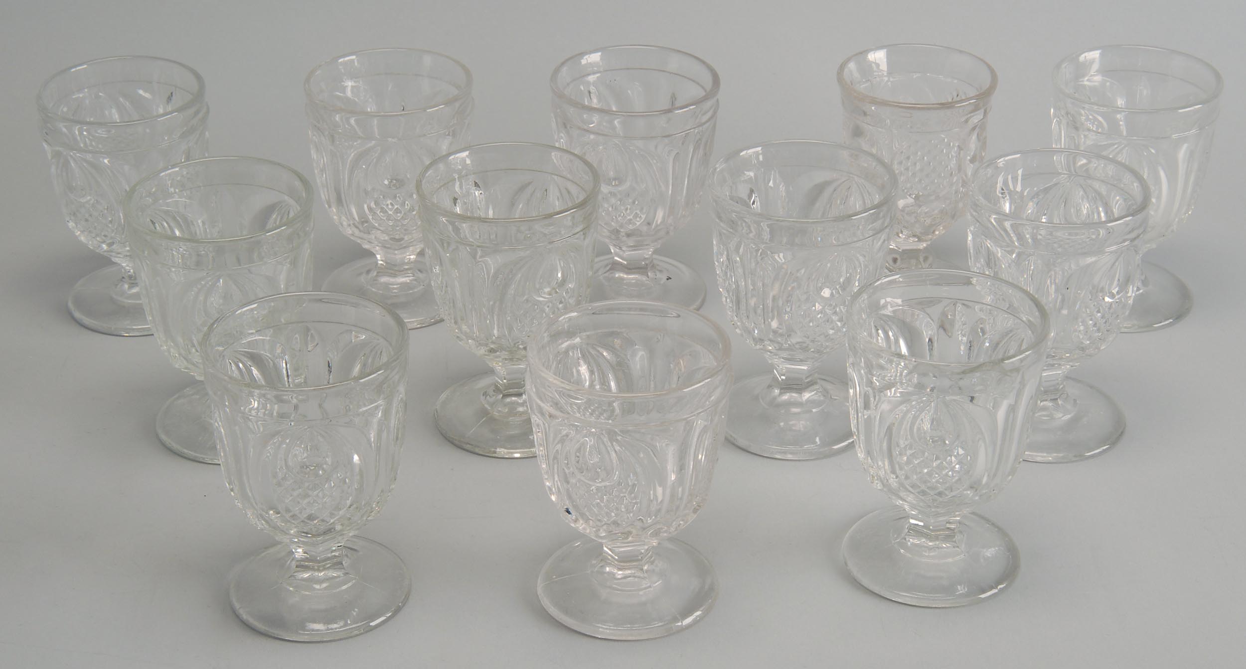 Appraisal: TWELVE MID- TH CENTURY PRESSED GLASS EGG CUPS eleven in