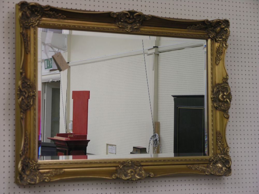 Appraisal: A period style gilt framed mirror with bevelled plate ft