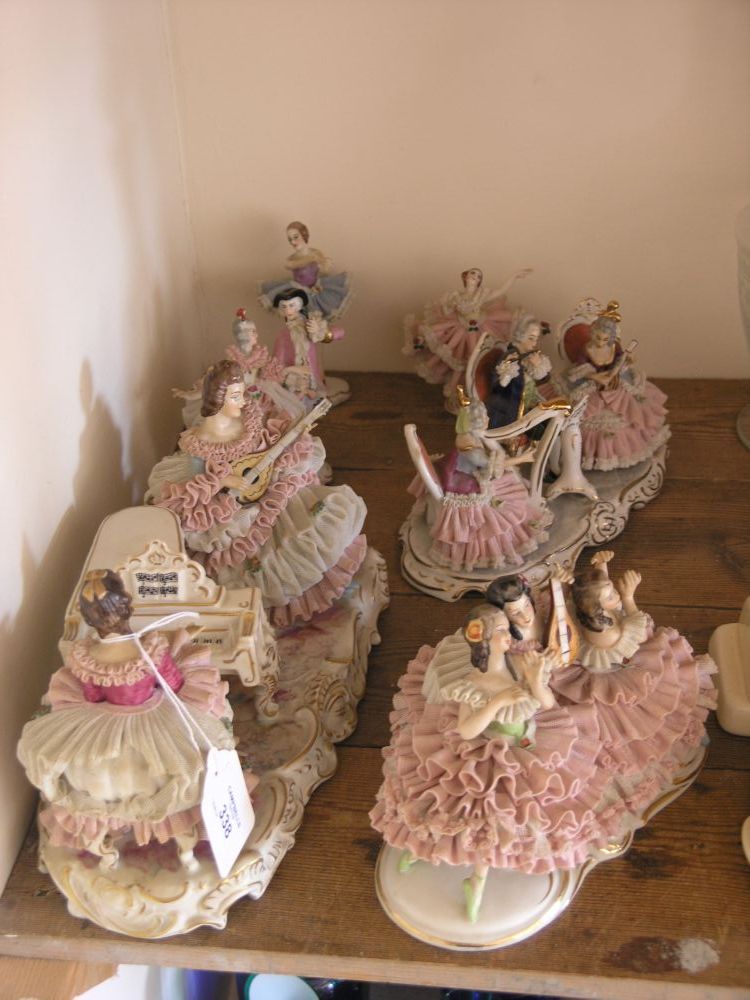 Appraisal: Six German porcelain figure groups all female figures wearing lace