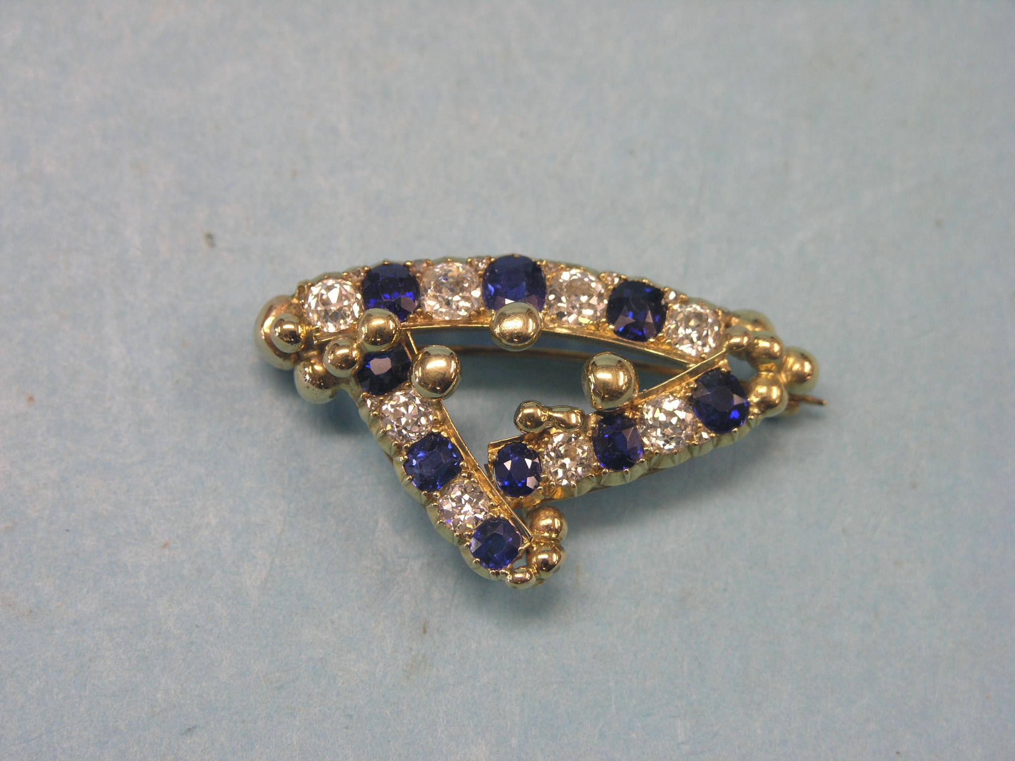 Appraisal: A yellow metal diamond and sapphire brooch eight diamonds nine