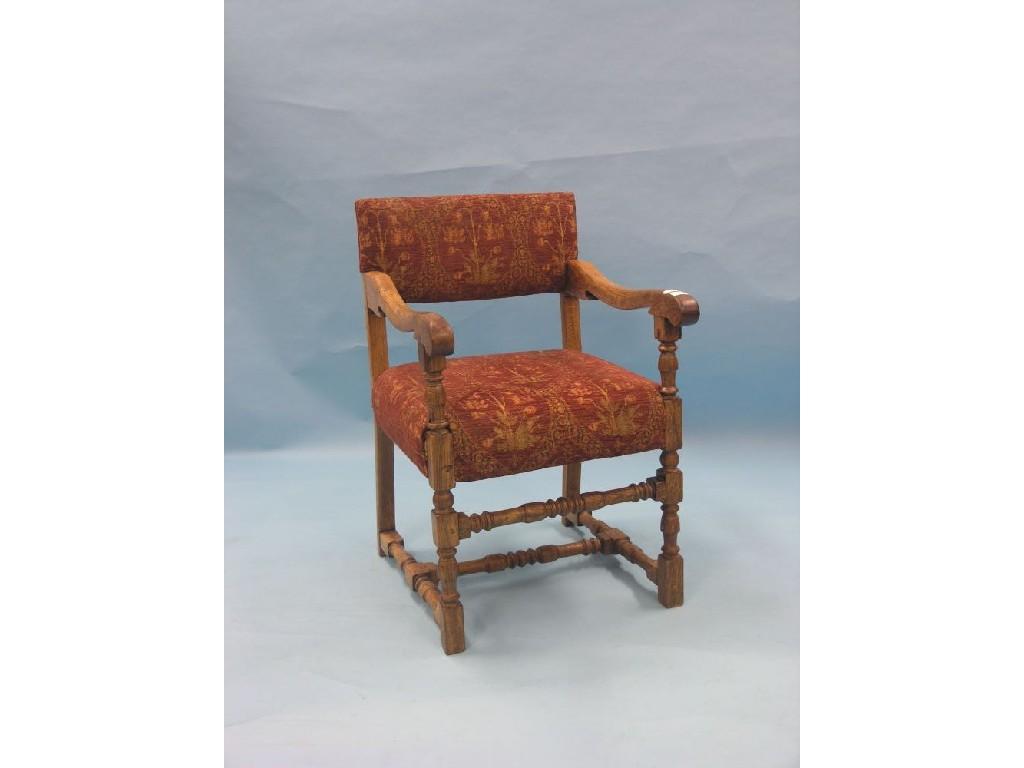 Appraisal: A th century-style oak elbow chair upholstered in a floral-stamped