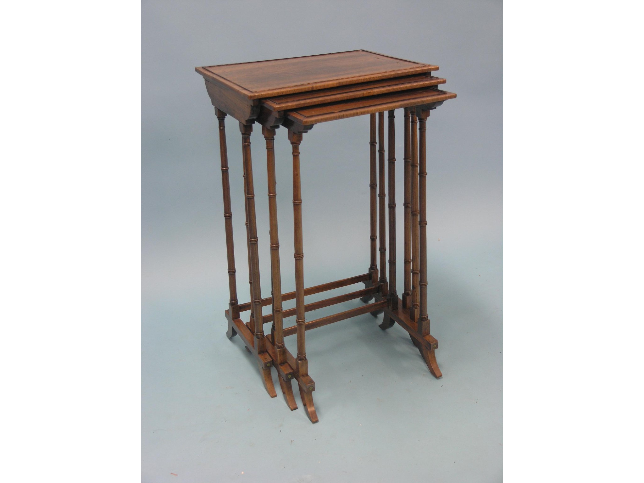 Appraisal: A Regency rosewood nest of three tables rectangular-shape with brass