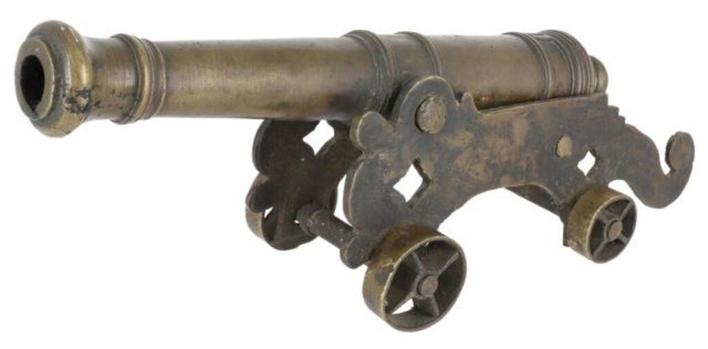 Appraisal: Patinated bronze signal cannon th c on scrolled carriage with