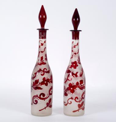 Appraisal: A pair of ruby and clear glass decanters and stoppers