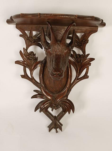 Appraisal: A BLACK FOREST STYLE WALL BRACKET the shaped shelf with