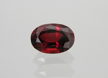 Appraisal: An Unmounted Pyrope Garnet Carat An oval brilliant cut pyrope