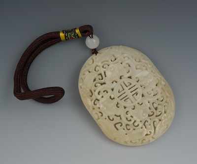 Appraisal: A Chinese Carved Jade Reticulated Pendant Grayish-white color jade pendant