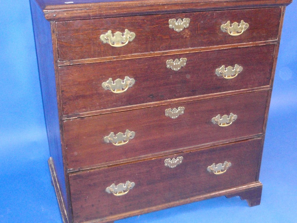 Appraisal: A George III oak chest of four graduated drawers with