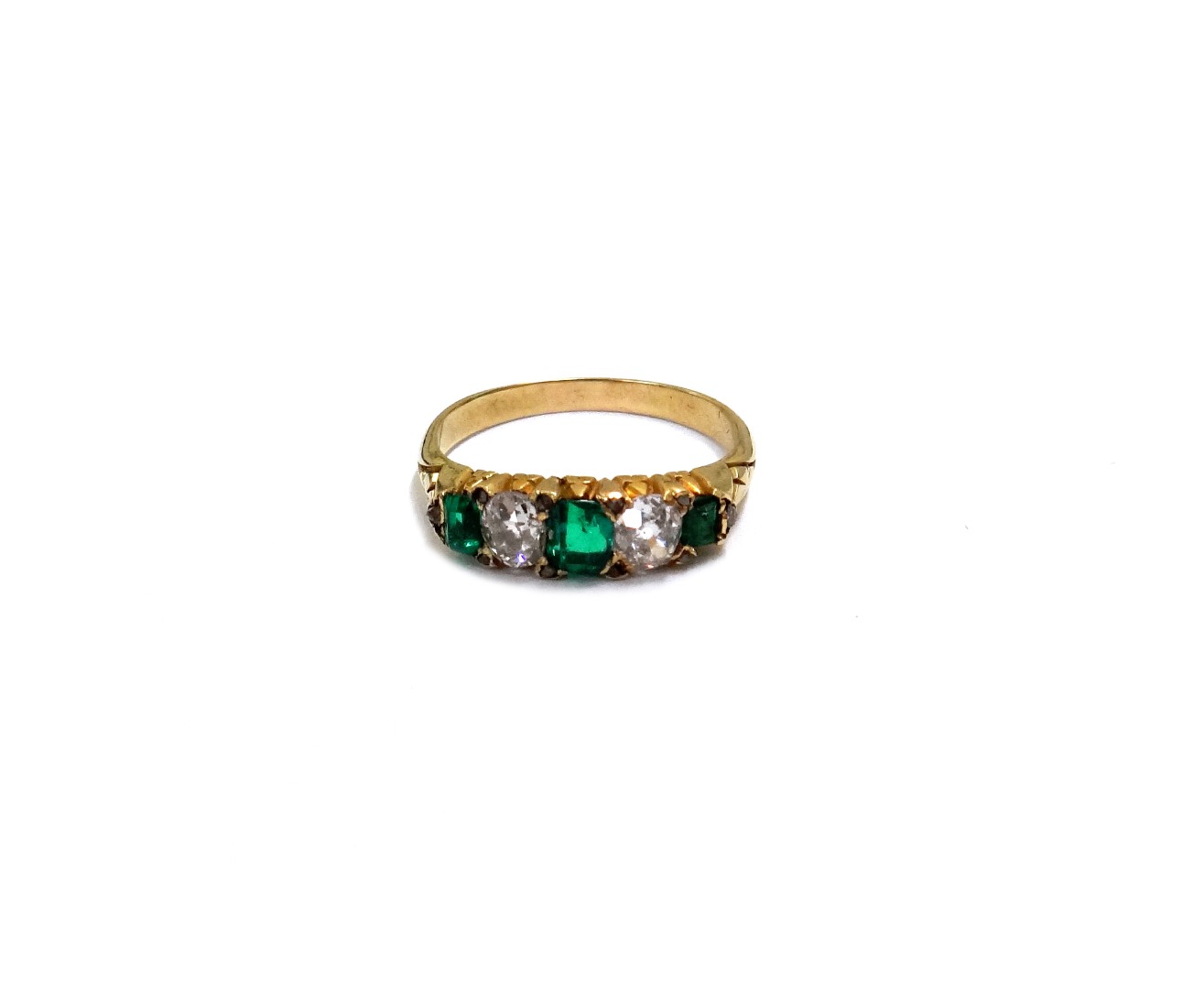 Appraisal: An Edwardian gold emerald and diamond five stone ring with