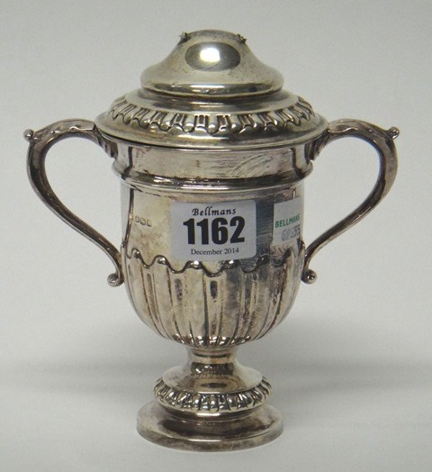 Appraisal: A silver twin handled trophy cup and cover with partly