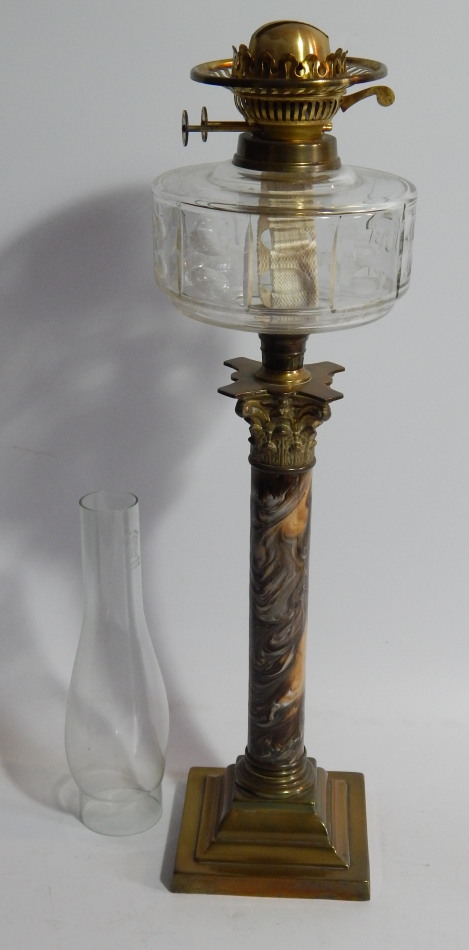 Appraisal: An Edwardian table oil lamp with faceted clear glass reservoir