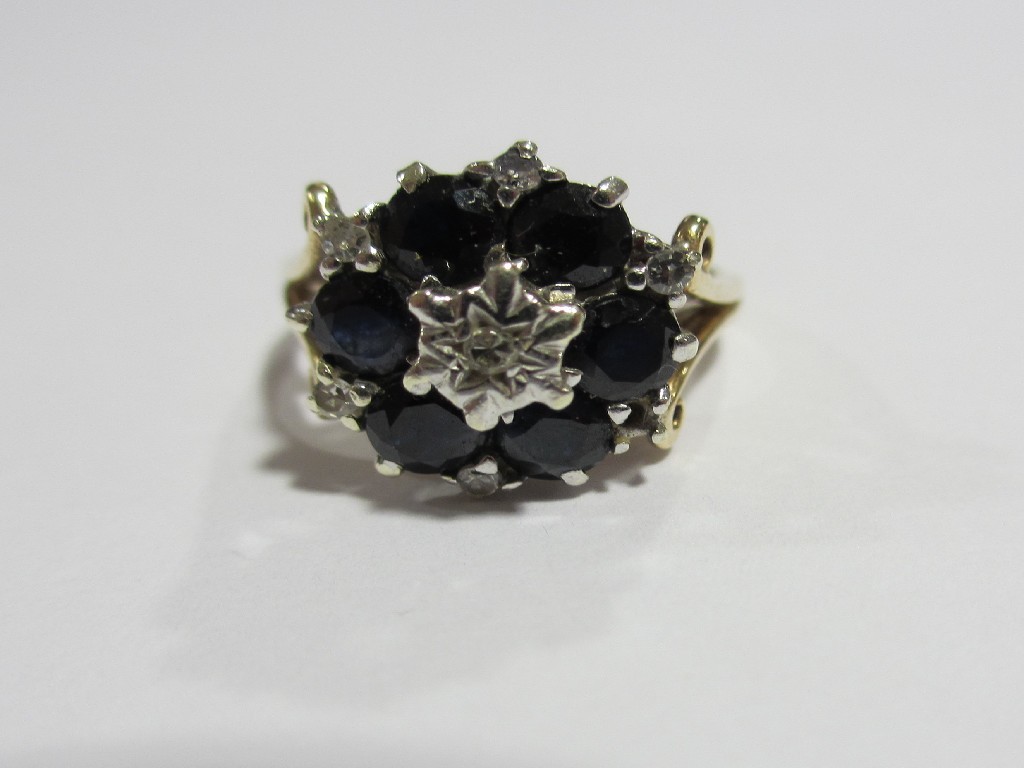 Appraisal: Nine carat gold sapphire and diamond cluster ring