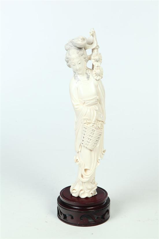 Appraisal: CARVED IVORY WOMAN China early th century Robed woman carrying