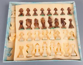 Appraisal: Carved Stone Chess Set Carved stone chess set contains board