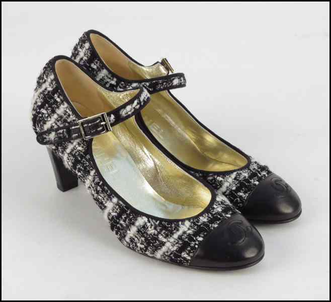 Appraisal: PAIR OF CHANEL BLACK AND WHITE WOOL AND LEATHER PUMPS