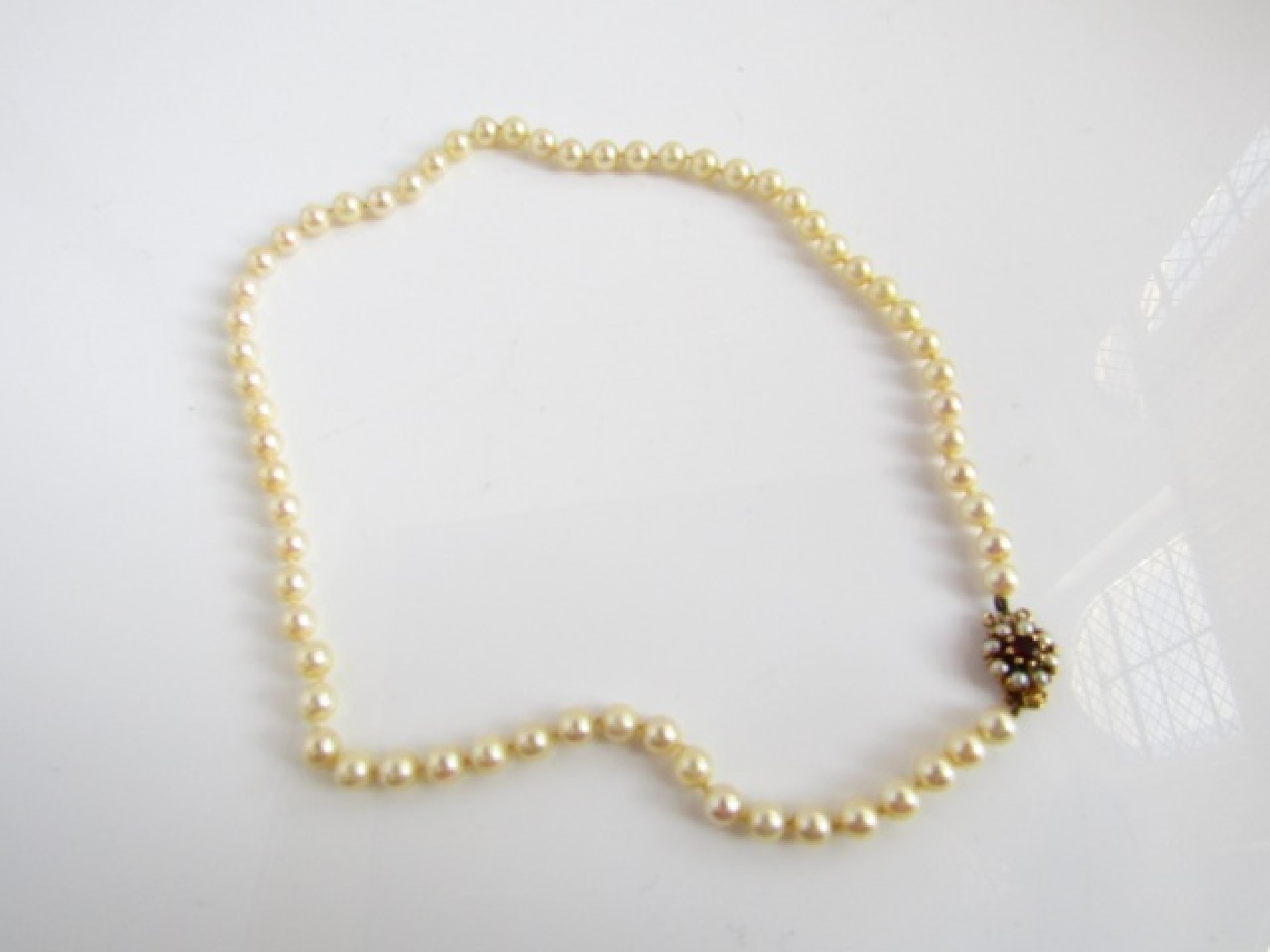 Appraisal: A strand of sixty-three pearls measuring mm x mm approx