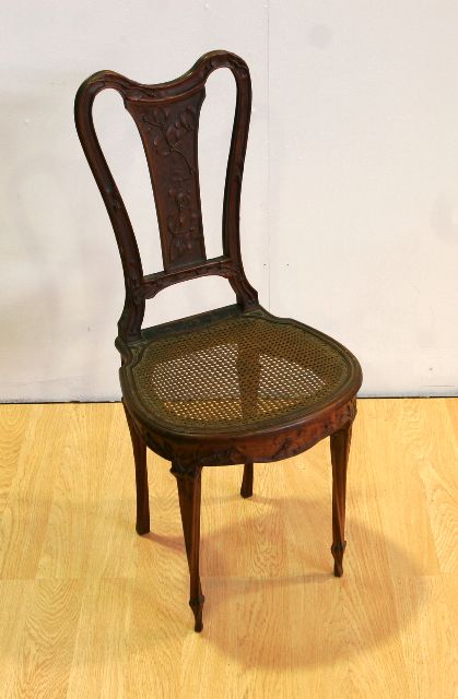 Appraisal: A French Art Nouveau walnut and caned occasional chair