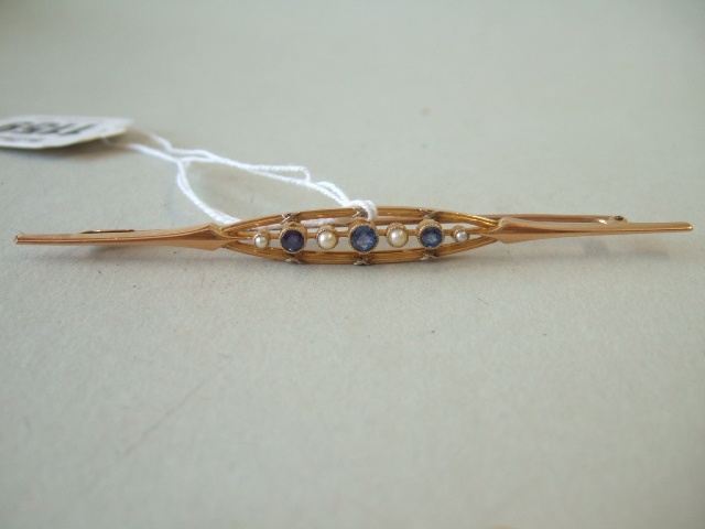 Appraisal: A gold sapphire and half pearl set bar brooch mounted