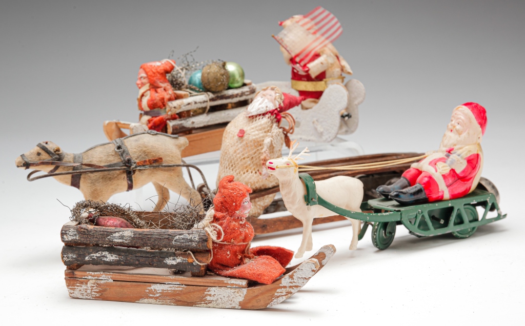 Appraisal: FIVE SANTAS WITH SLEDS AND SLEIGHS Twentieth century Wooden wind-up