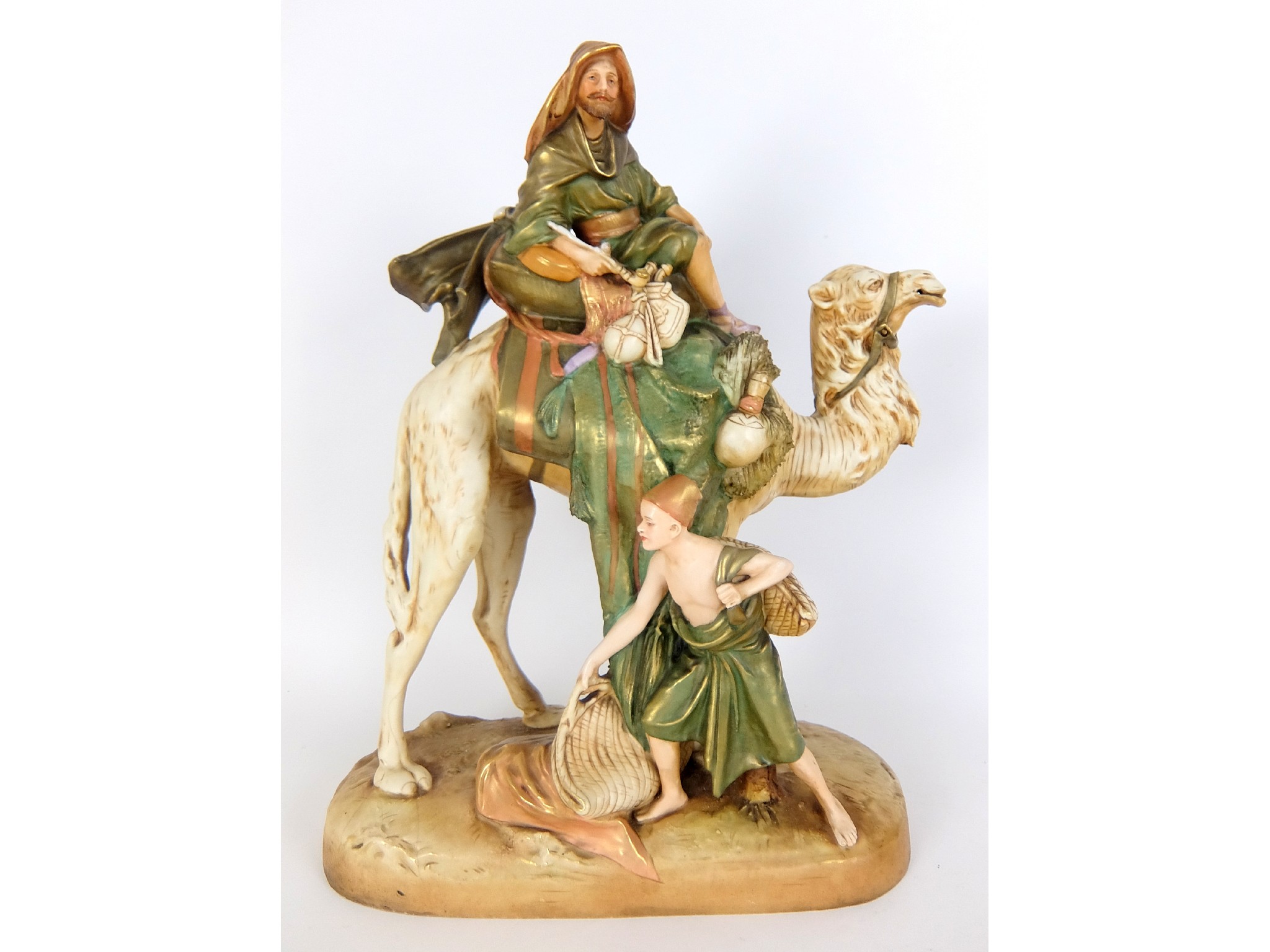 Appraisal: A Royal Dux model of a camel with two menfigures