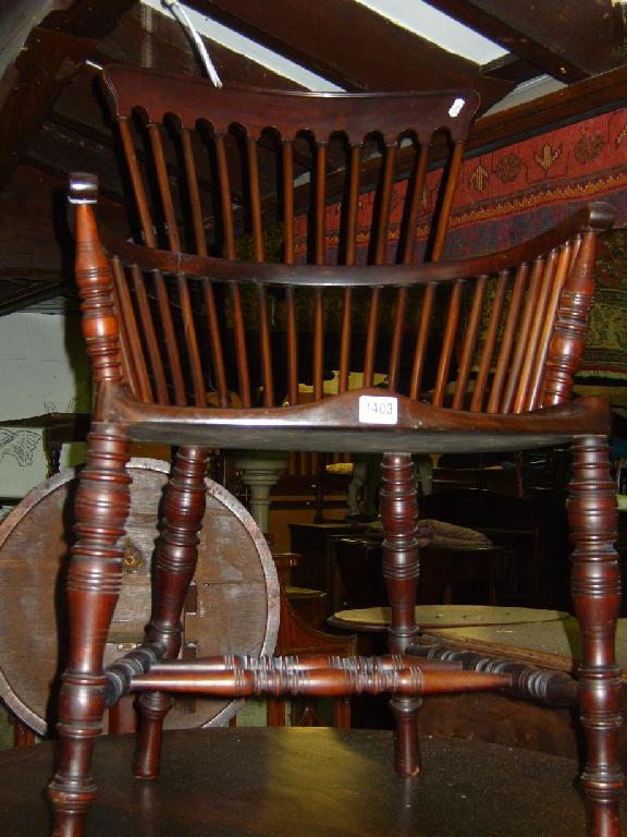 Appraisal: An Edwardian walnut armchair with raised stylised stick back turned