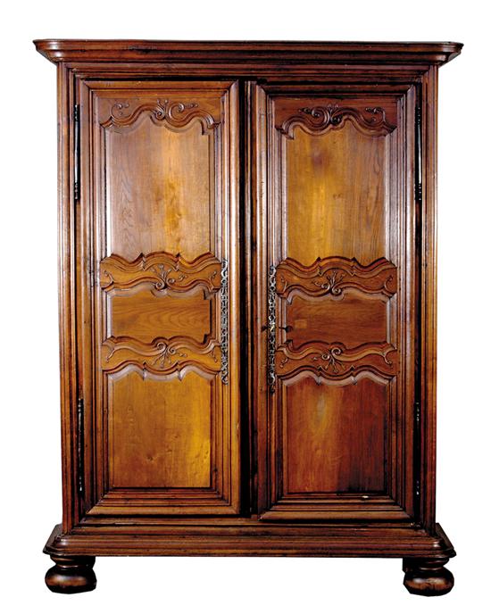 Appraisal: French Provincial fruitwood armoire late th century molded cornice above