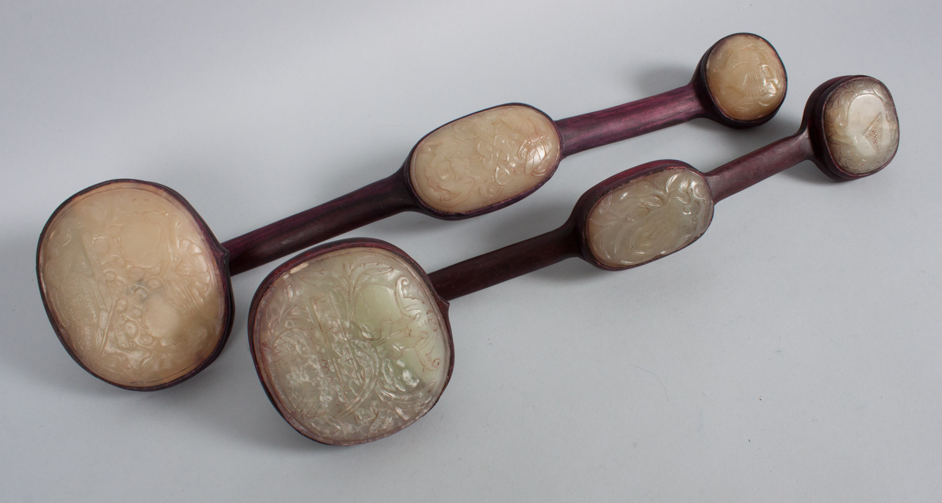 Appraisal: Two Chinese carved wood and hardstone ruyis each scepter having