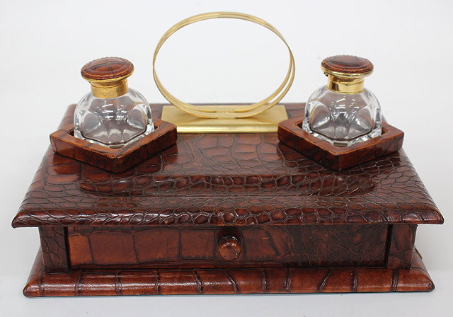 Appraisal: A CROCODILE SKIN DESK STAND with two glass and gilt