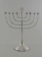 Appraisal: Judaica - a silver Menorah the plain slender column on