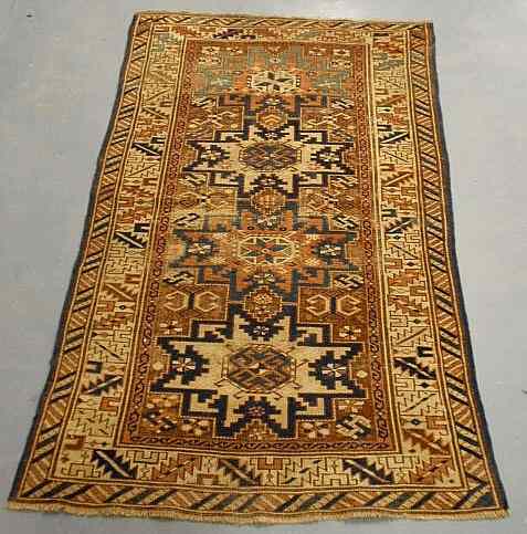 Appraisal: Oriental hall mat with overall geometric medallions ' x '