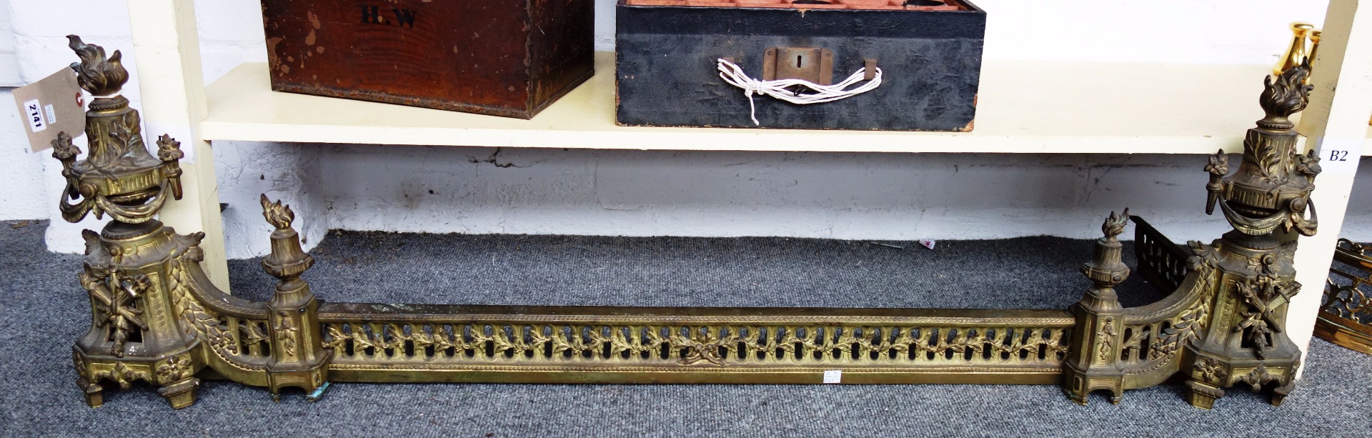 Appraisal: An Empire style gilt metal adjustable fire curb with flaming